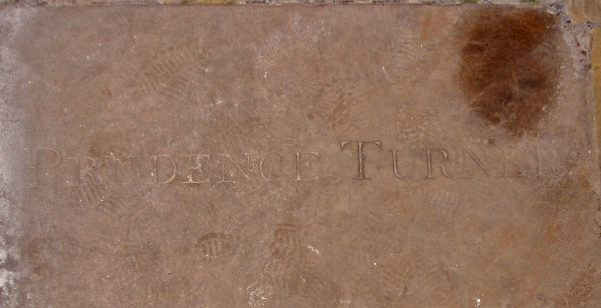 A stone set in the church floor bearing the name Prudence Turner